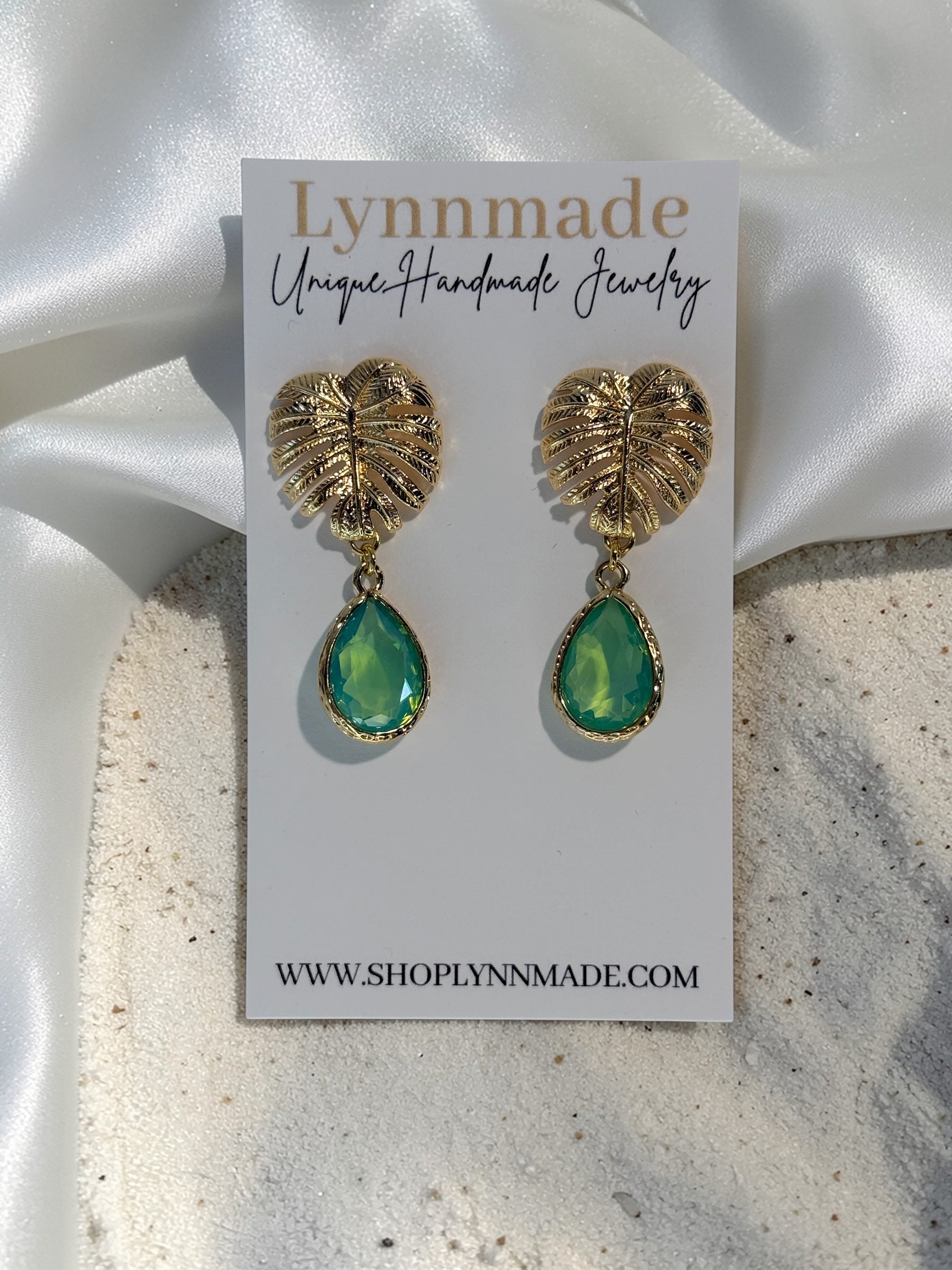 Handmade gold Monstera leaf statement earrings with peridot green teardrop glass charms