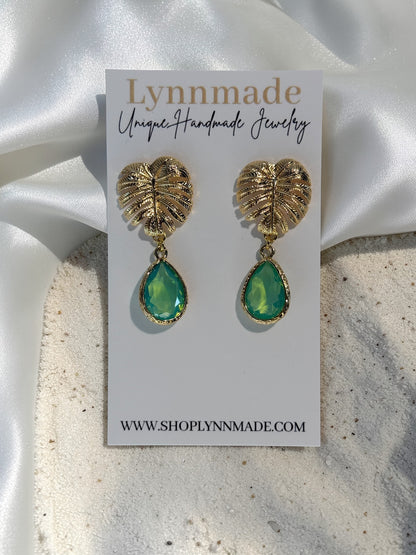Handmade gold Monstera leaf statement earrings with peridot green teardrop glass charms
