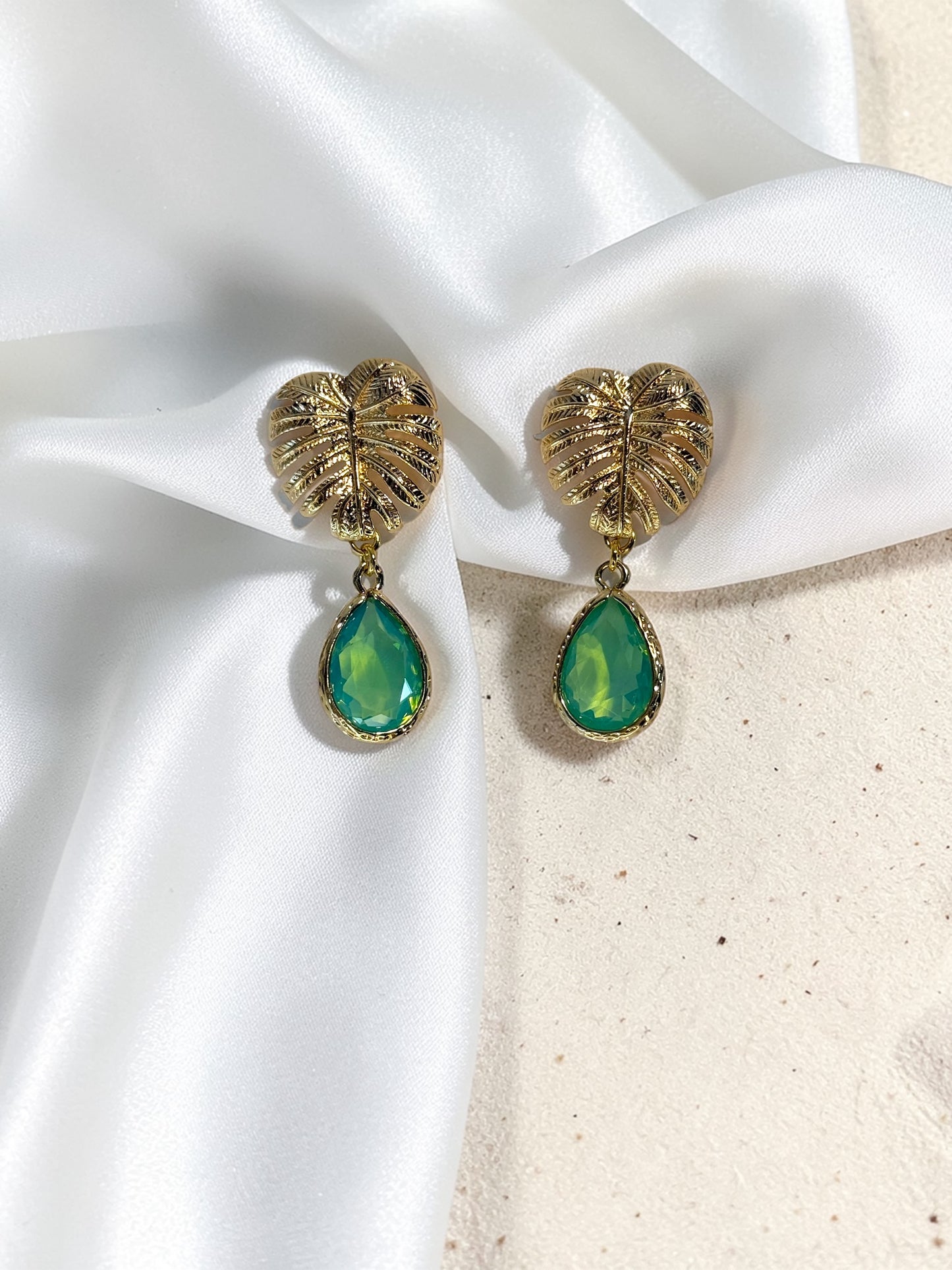 Handmade gold Monstera leaf statement earrings with peridot green teardrop glass charms