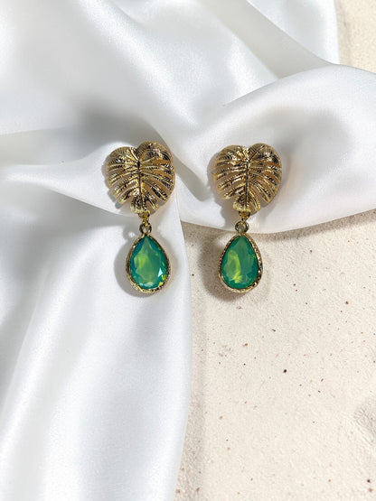 Handmade gold Monstera leaf statement earrings with peridot green teardrop glass charms