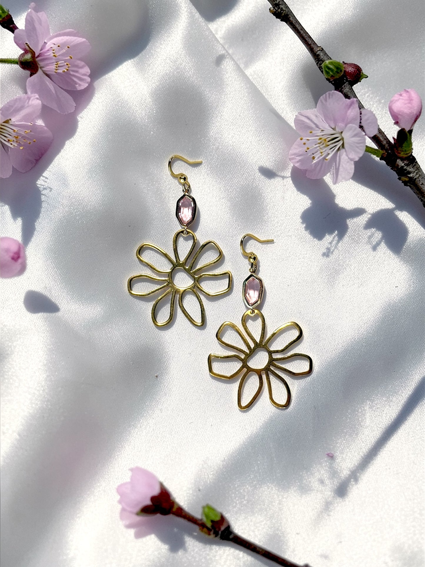 Handmade gold wire flower earrings with a light pink faceted gemstone