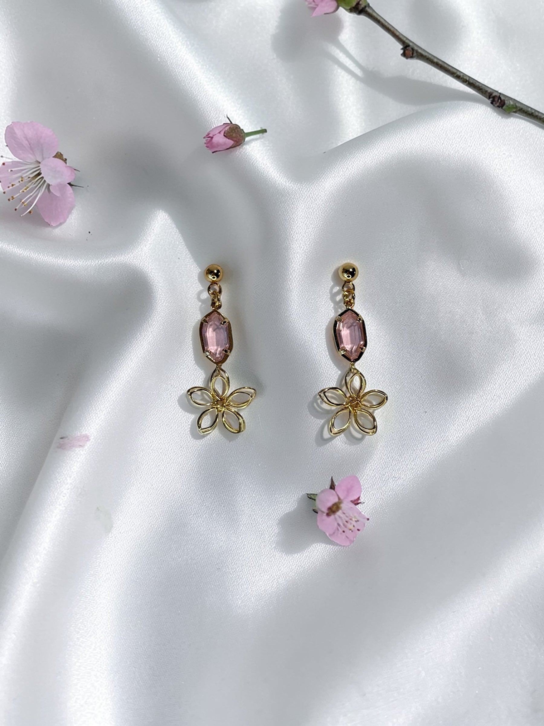 Handmade dainty gold wire flower earrings with a light pink faceted gemstone