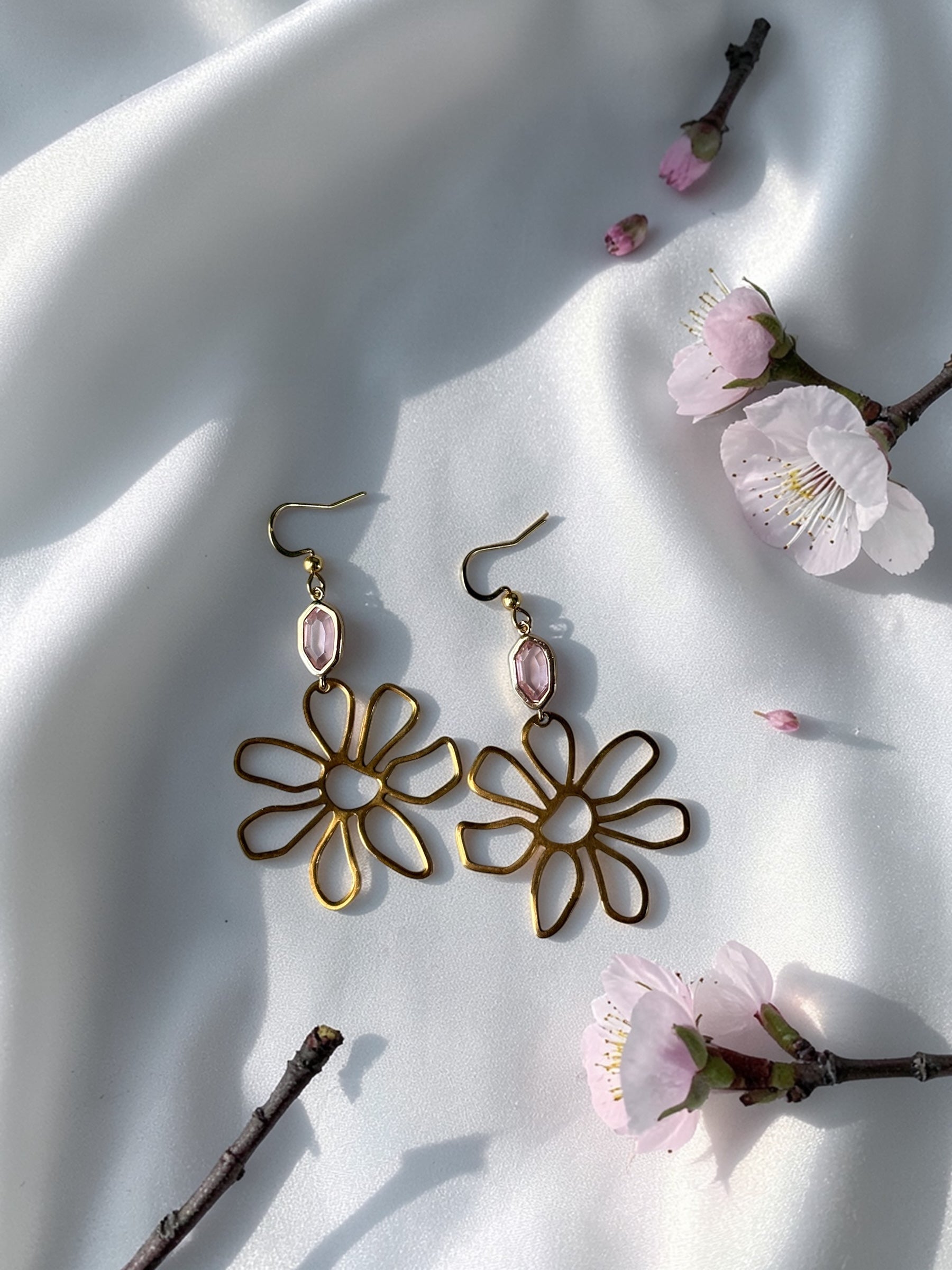 Handmade gold wire flower earrings with a light pink faceted gemstone