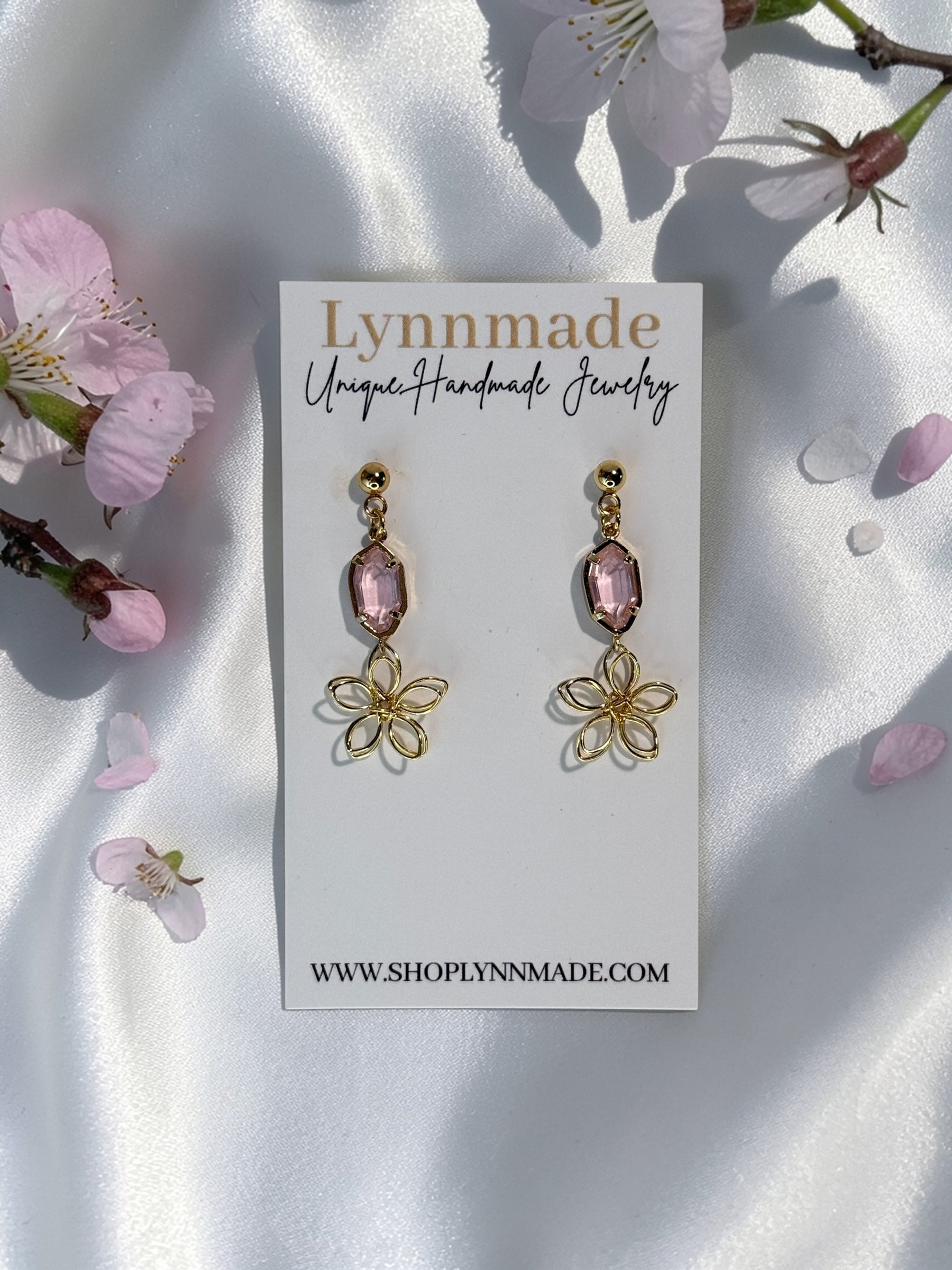 Handmade dainty gold wire flower earrings with a light pink faceted gemstone