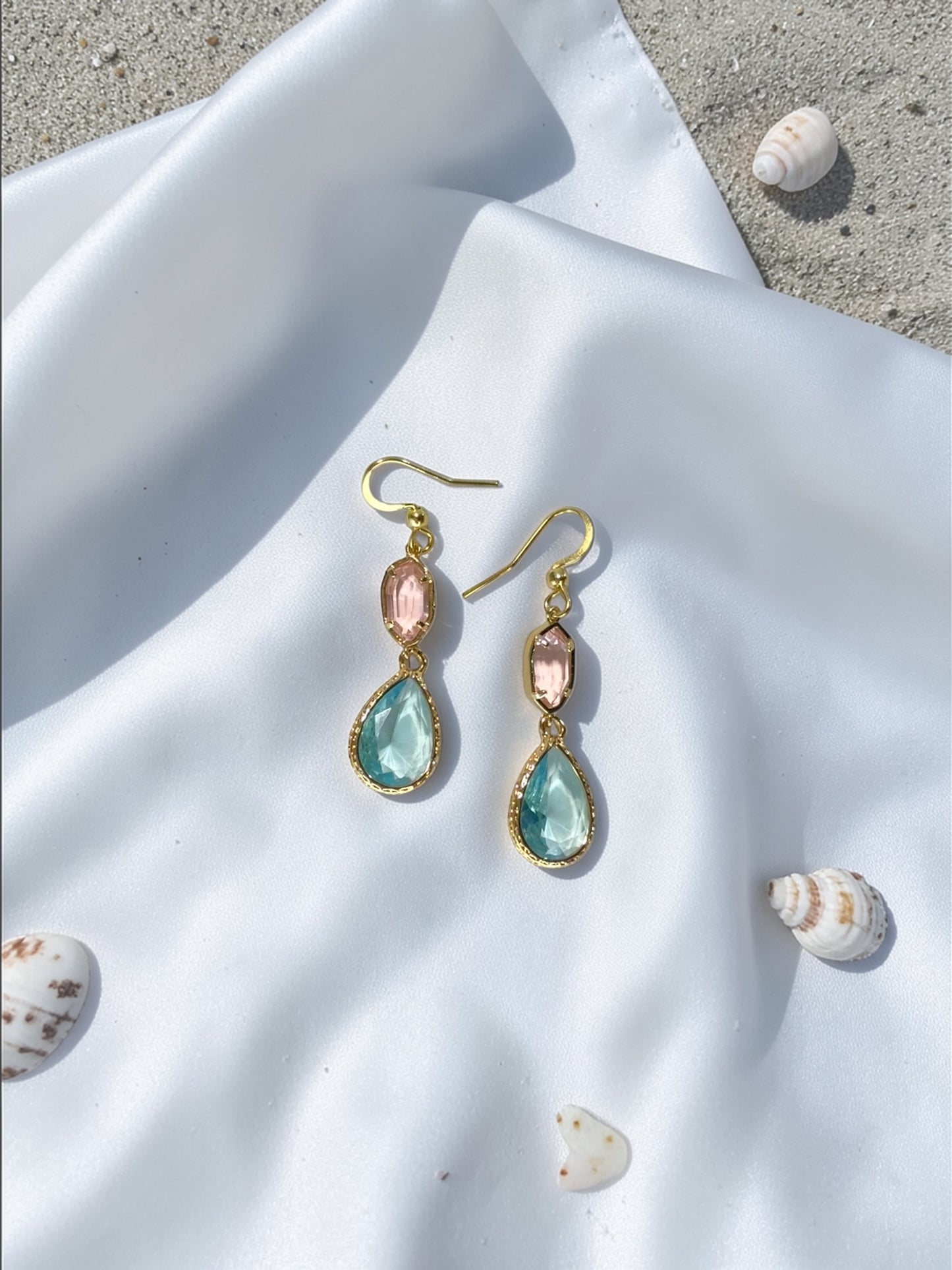 Handmade gold teardrop earrings with a seafoam blue crystal and a blush pink accent